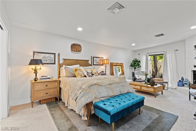 bedroom with a fireplace and carpet floors