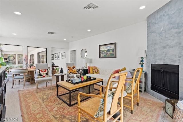 dining area with light hardwood / wood-style flooring and a fireplace