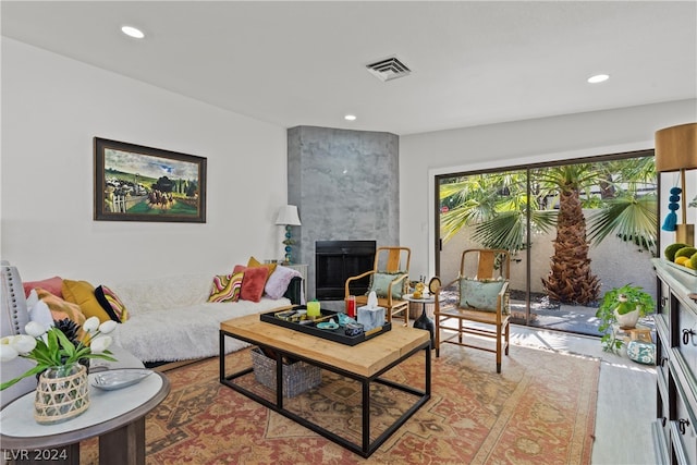 living room with a tiled fireplace