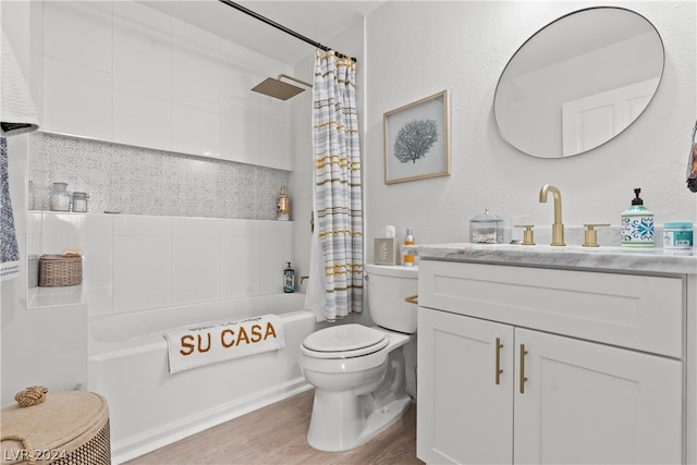 full bathroom with hardwood / wood-style floors, vanity, shower / bath combo, toilet, and decorative backsplash