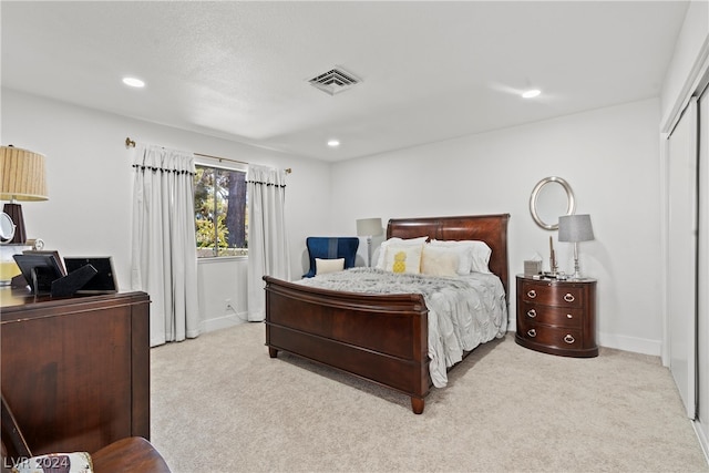 carpeted bedroom with a closet