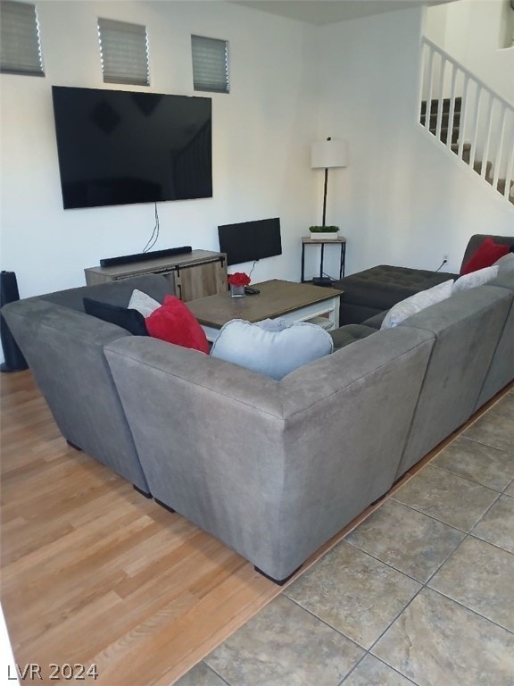 living room featuring stairs and wood finished floors