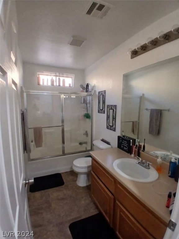 full bath with toilet, shower / bath combination with glass door, visible vents, and vanity