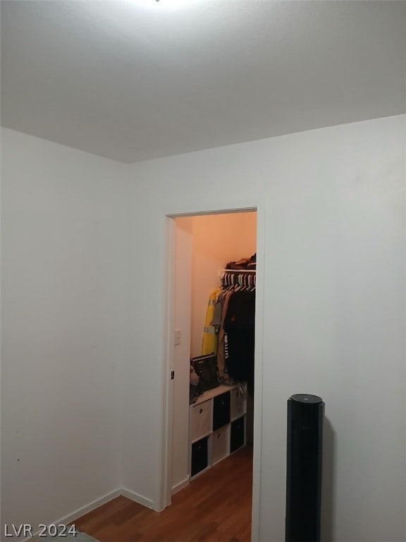 hall featuring baseboards and dark wood-type flooring