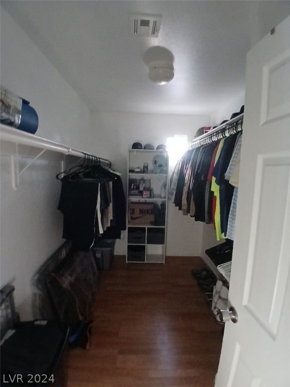 walk in closet featuring visible vents and wood finished floors