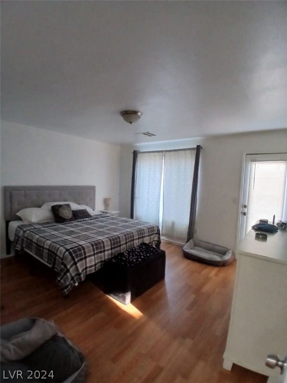 bedroom featuring visible vents and wood finished floors