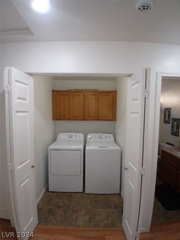 laundry area featuring washing machine and dryer and cabinet space