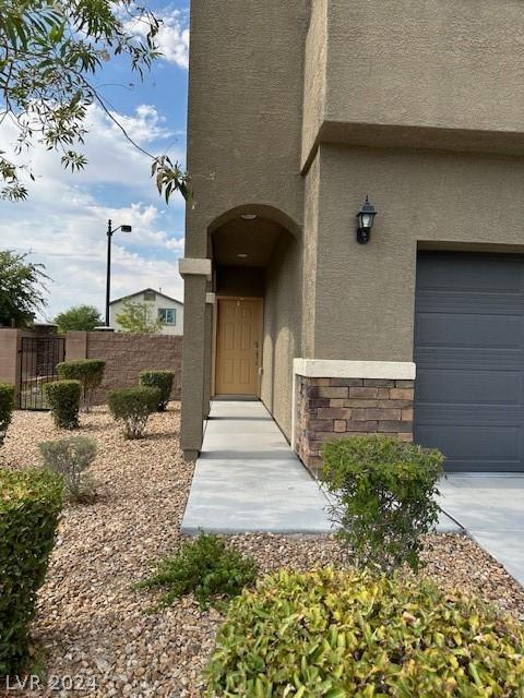 doorway to property with a garage