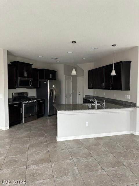 kitchen featuring light tile patterned flooring, sink, appliances with stainless steel finishes, kitchen peninsula, and pendant lighting