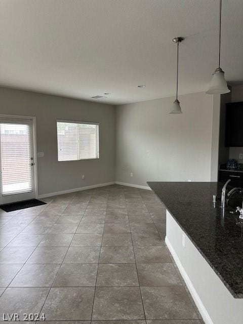 interior space with tile patterned flooring, sink, a wealth of natural light, and a textured ceiling