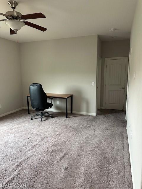 unfurnished office featuring light colored carpet and ceiling fan