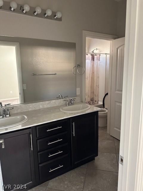 bathroom with tile patterned flooring, vanity, a shower with curtain, and toilet