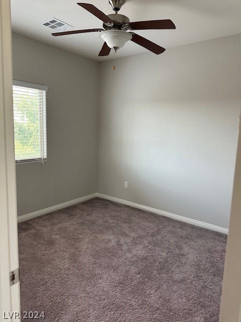 carpeted empty room featuring ceiling fan