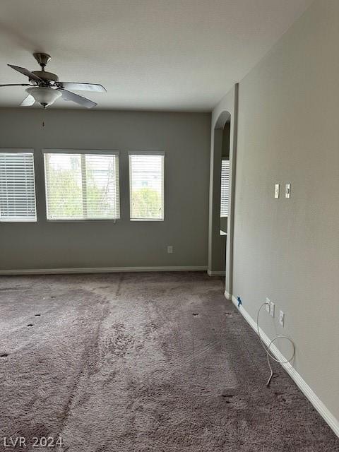 carpeted empty room with ceiling fan