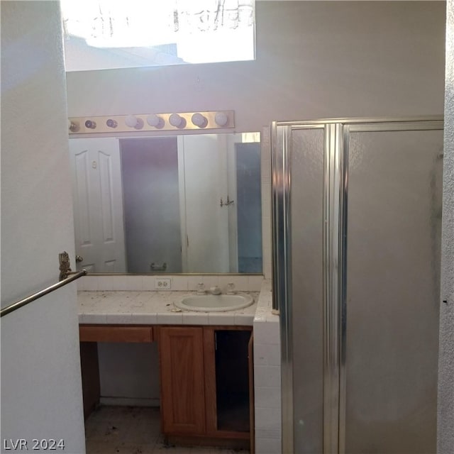 bathroom with vanity, walk in shower, and tile patterned flooring