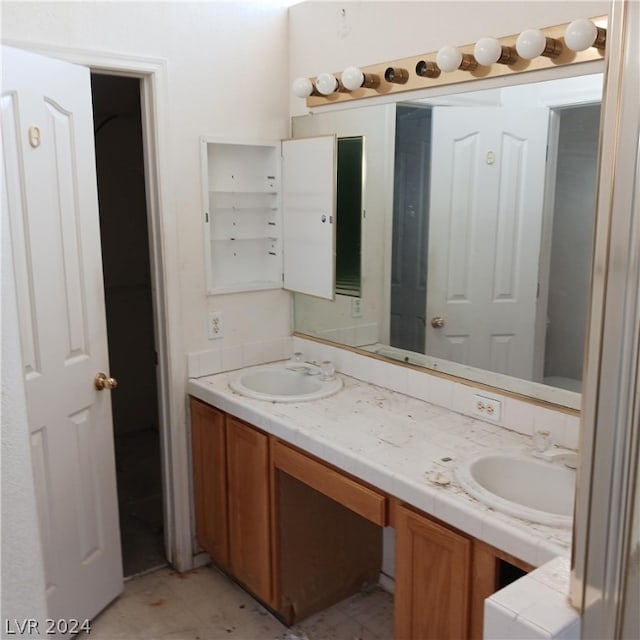 bathroom featuring tile patterned flooring and double sink vanity