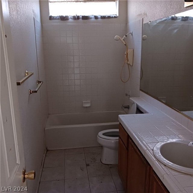 full bathroom with vanity, tiled shower / bath combo, toilet, and a healthy amount of sunlight