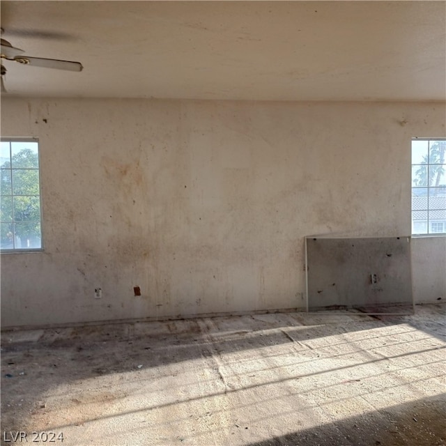 empty room with a healthy amount of sunlight and ceiling fan