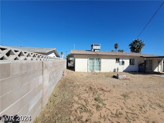 rear view of property with central air condition unit