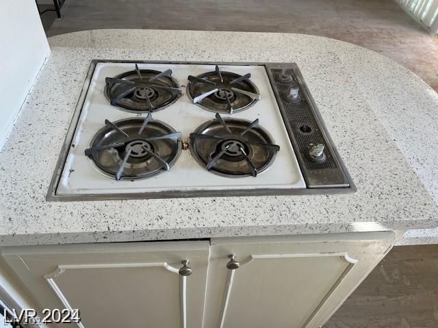 details with white gas cooktop and light stone counters