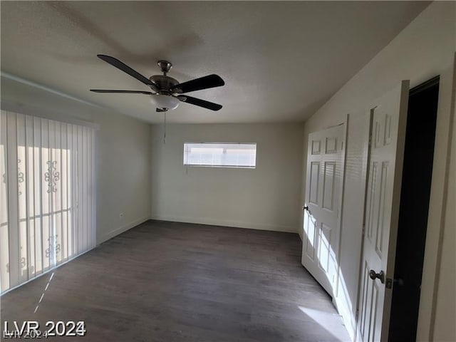 spare room featuring ceiling fan and dark hardwood / wood-style flooring