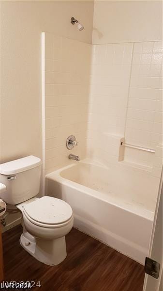 bathroom featuring toilet, shower / bathtub combination, and hardwood / wood-style floors