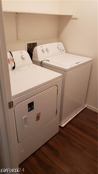 laundry room with washer and dryer and dark hardwood / wood-style flooring