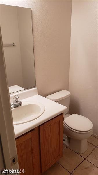 bathroom featuring toilet, tile patterned floors, and vanity