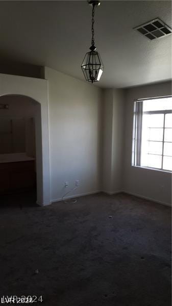 unfurnished dining area with dark carpet