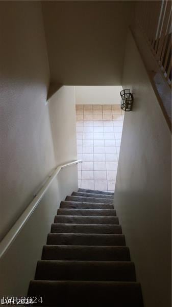 stairway with tile patterned flooring