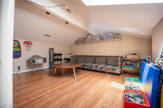 playroom featuring visible vents, vaulted ceiling with beams, baseboards, and wood finished floors