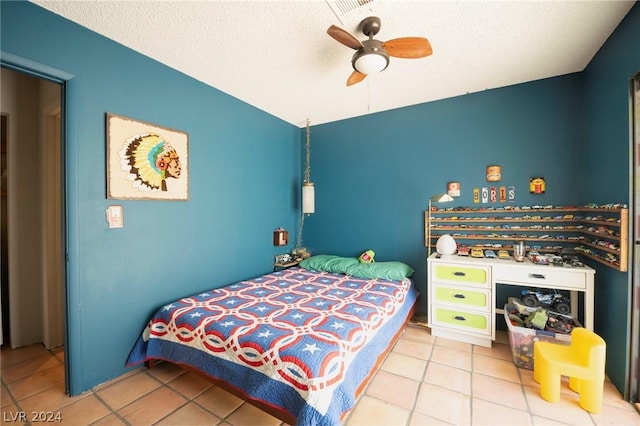 tiled bedroom with ceiling fan, vaulted ceiling, and a textured ceiling