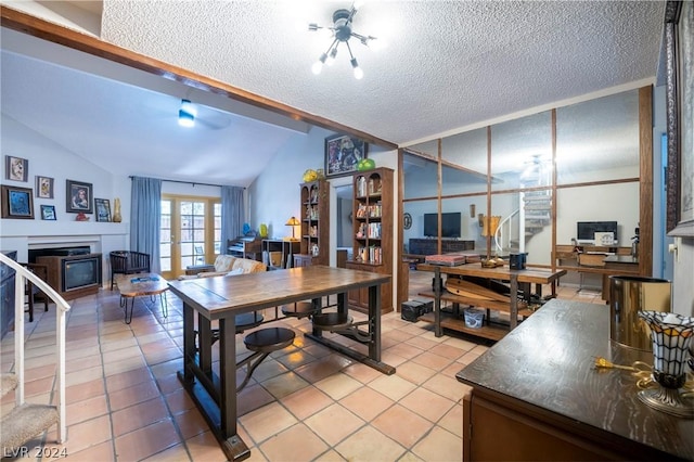 office featuring vaulted ceiling, french doors, a textured ceiling, and light tile patterned floors