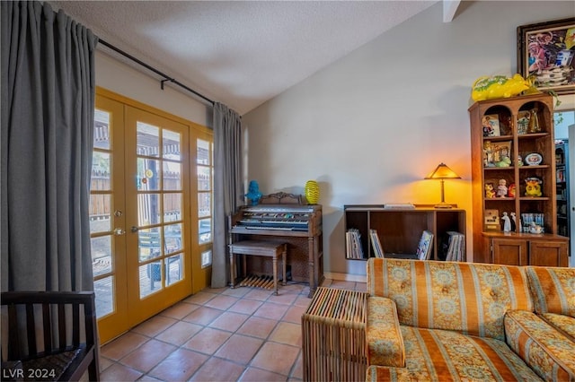 interior space with lofted ceiling, tile patterned floors, a textured ceiling, and french doors