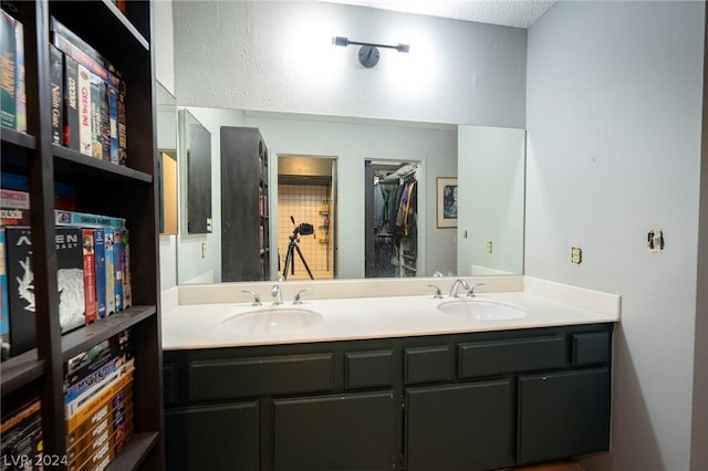 bathroom with a sink and double vanity