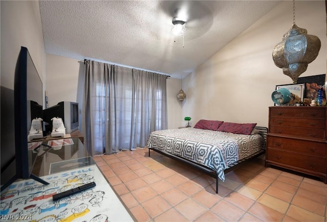 bedroom featuring vaulted ceiling, ceiling fan, a textured ceiling, and light tile patterned flooring