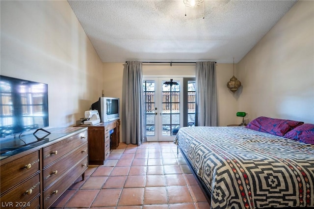 bedroom featuring light tile patterned floors, access to outside, a textured ceiling, and french doors