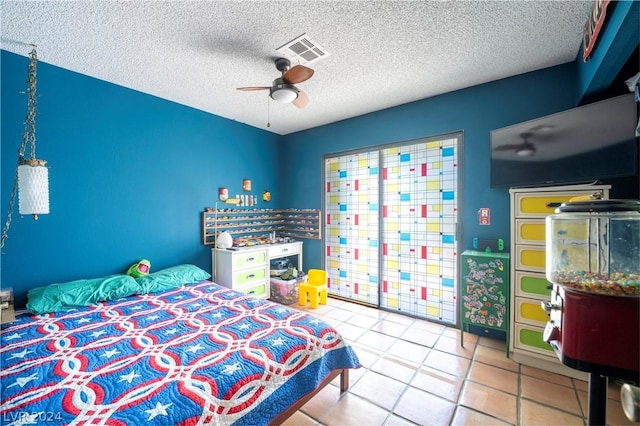 bedroom with visible vents, ceiling fan, a textured ceiling, and tile patterned floors