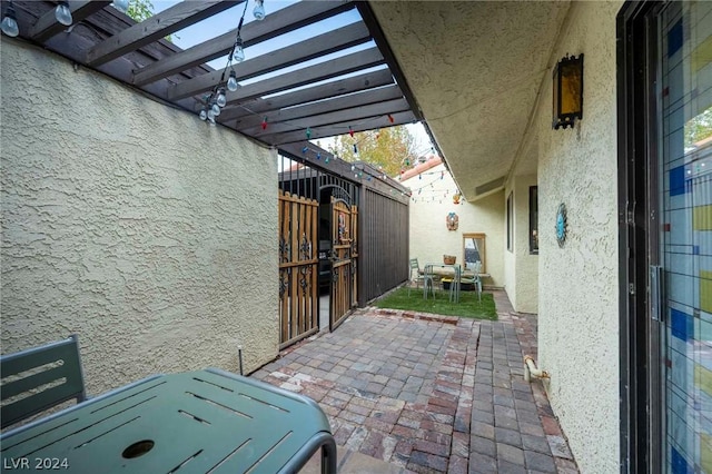 view of patio / terrace featuring fence and a pergola