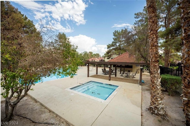 view of pool with a gazebo, fence, and a patio