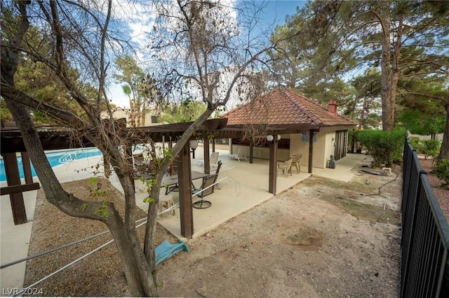 exterior space featuring a patio area, a swimming pool, and fence