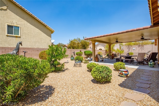 view of yard with a patio area and ceiling fan