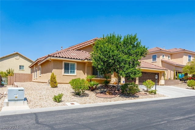 mediterranean / spanish-style home with a garage