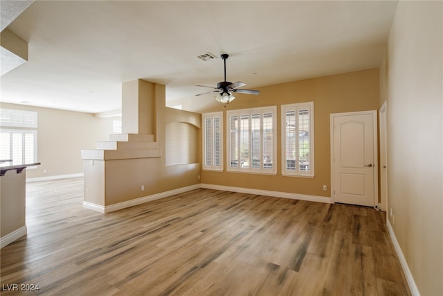 unfurnished living room featuring light hardwood / wood-style floors and ceiling fan