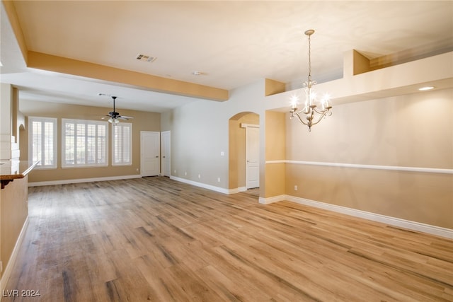 interior space with light wood-type flooring and ceiling fan with notable chandelier