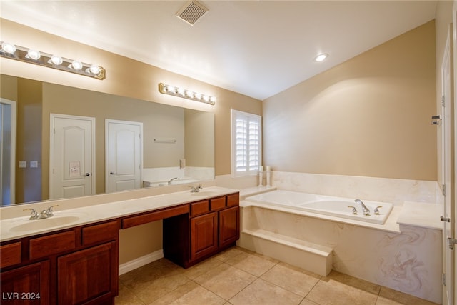 bathroom with vanity, tile patterned flooring, and a washtub