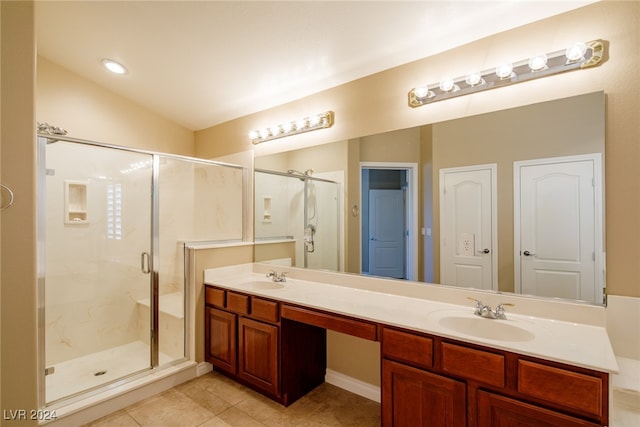 bathroom featuring vanity, vaulted ceiling, tile patterned flooring, and an enclosed shower