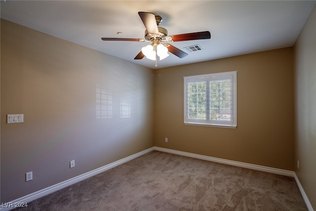 empty room featuring light colored carpet and ceiling fan