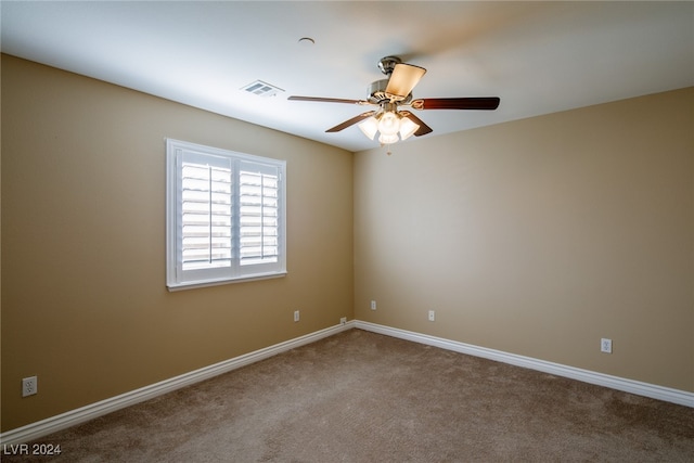 spare room featuring carpet flooring and ceiling fan