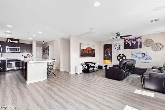 living room featuring light hardwood / wood-style floors and ceiling fan